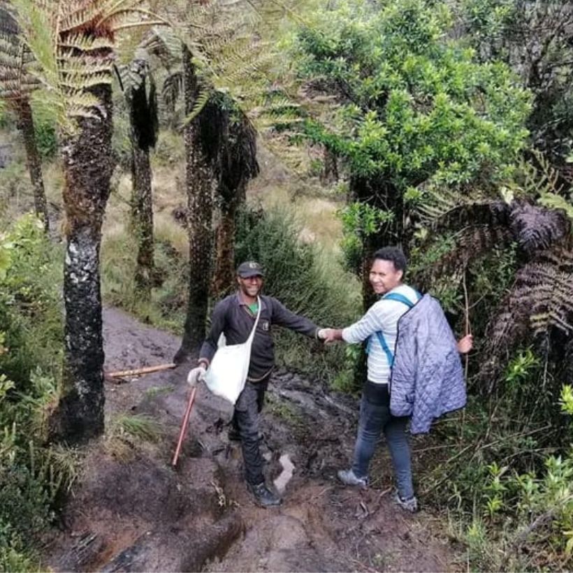 Guide Leading Trekker Back after Summit